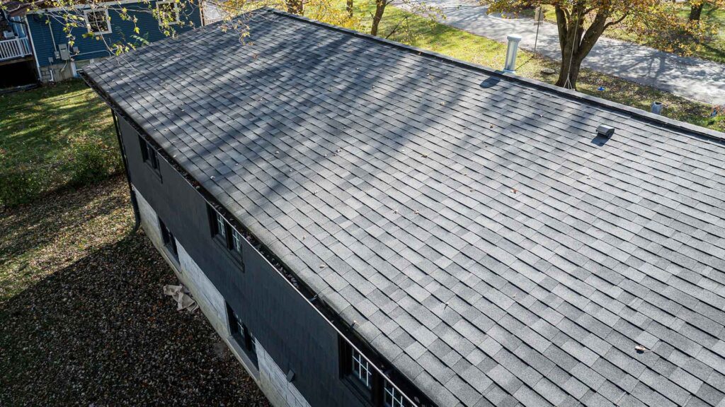 A newly installed black shingle roof showcasing high-quality roofing services for long-lasting durability and weather resistance.