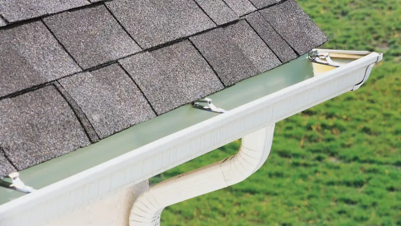 A close-up of a properly installed gutter system as part of roofing services to ensure efficient water drainage and roof protection.