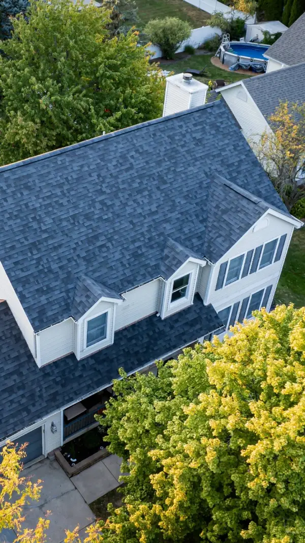 A newly installed dark gray shingle roof on a residential home.