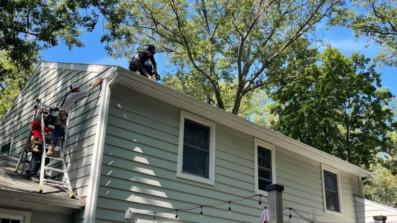 Contractors performing roof repair on a two-story home, ensuring long-lasting protection and high-quality craftsmanship.
